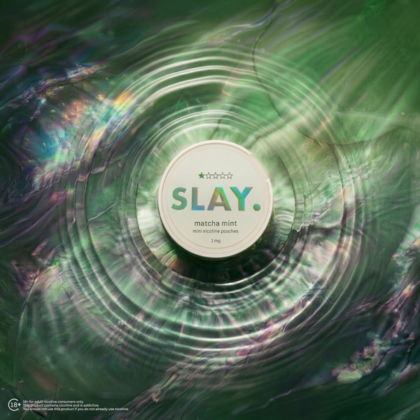 SLAY Matcha Mint nicotine pouch placed at the centre of shimmering green ripples with an iridescent liquid-style background.