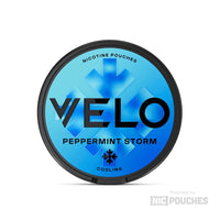 VELO Peppermint Storm nicotine pouches tin with bold blue design for intense minty freshness, plant-based fibres, tobacco-free.